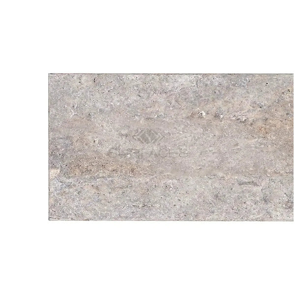Textured gray stone slab of Silver Gray Travertine 8X16 Unfilled Brushed Chiseled Edge