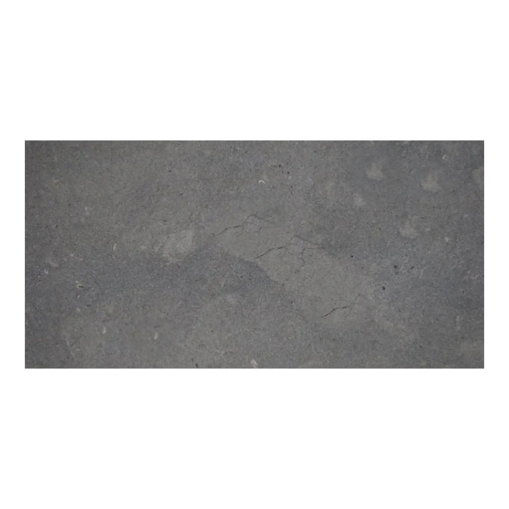 Silvermoor 12x24 honed limestone slab with gray concrete texture and faint cracks