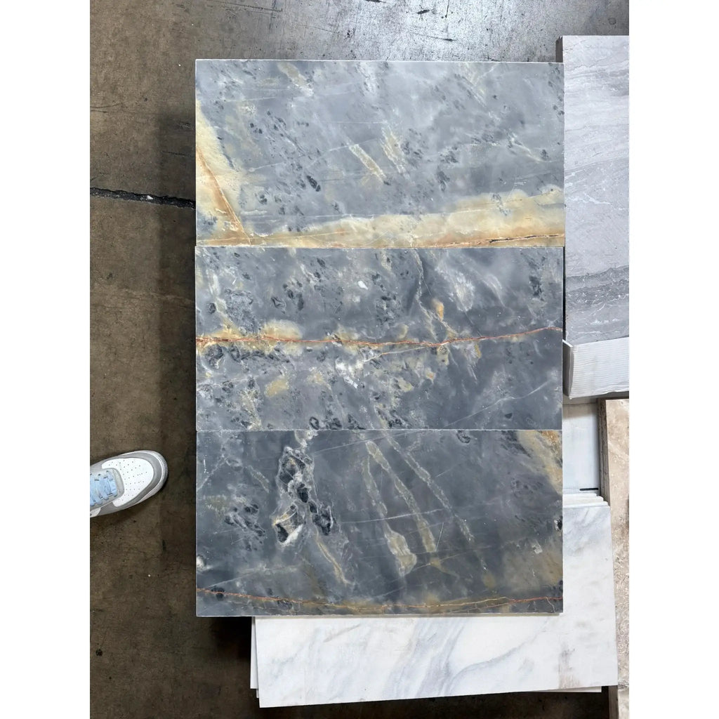 Gray marble tile with gold veining from Sky Blue Azul Cielo 12X24 Marble Tile