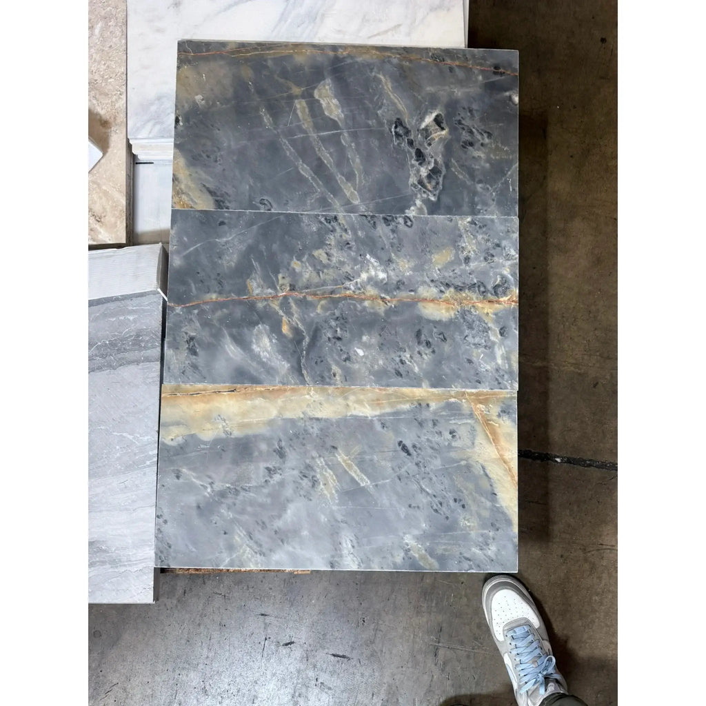 Gray marble slabs with brown veining in Sky Blue Azul Cielo 12X24 Marble Tile