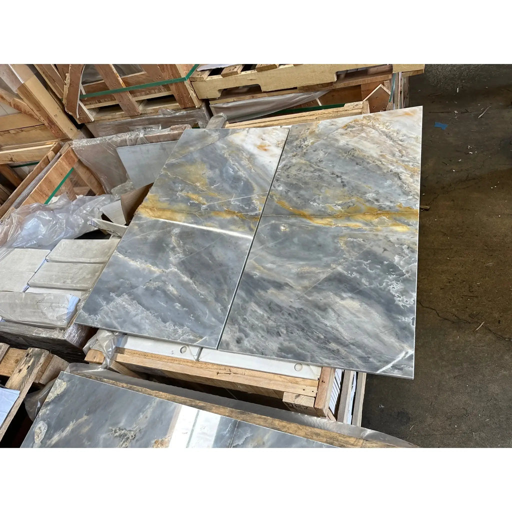 Gray marble tiles with gold veining in Sky Blue Azul Cielo 12X24 Marble Tile design