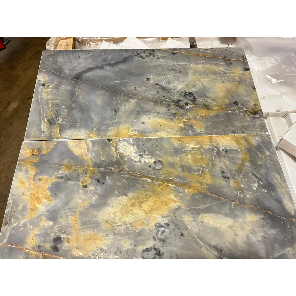 Two gray and gold marble slabs for Sky Blue Azul Cielo 12X24 Marble Tile