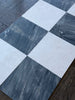 Black and white checkered marble floor tiles from Sky Blue Azul Cielo 18X18 collection
