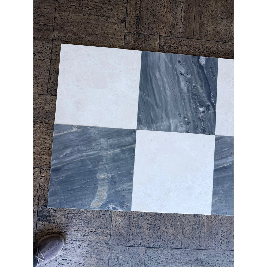 Checkerboard pattern of white and gray marble tiles from Sky Blue Azul Cielo collection