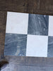 Checkerboard pattern of white and gray marble tiles from Sky Blue Azul Cielo collection
