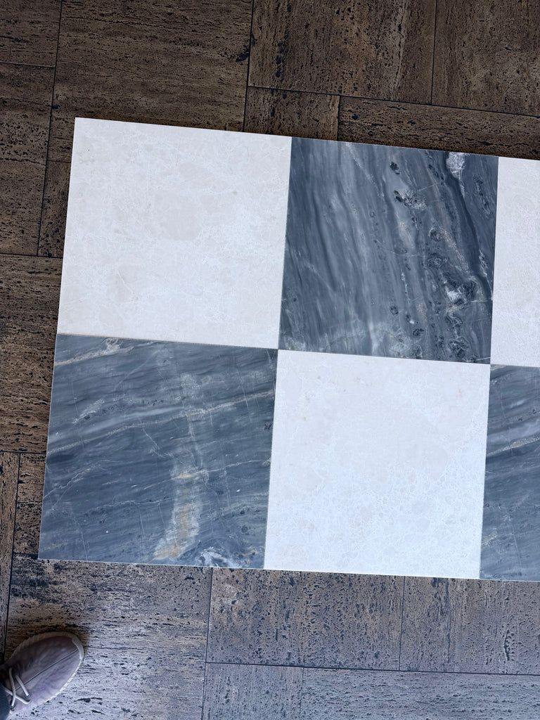 Checkerboard pattern of white and gray marble tiles from Sky Blue Azul Cielo collection