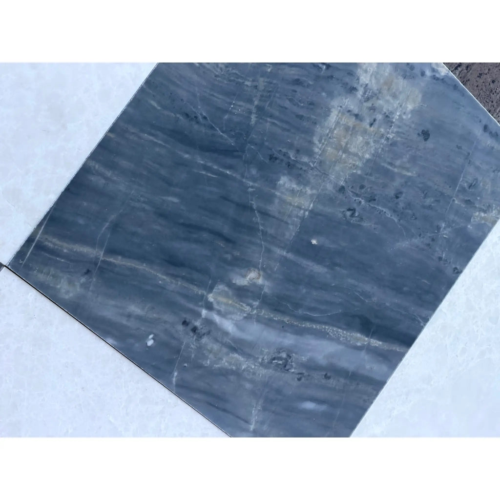 Dark blue-grey marble tile with white and light grey veining from Sky Blue Azul Cielo collection
