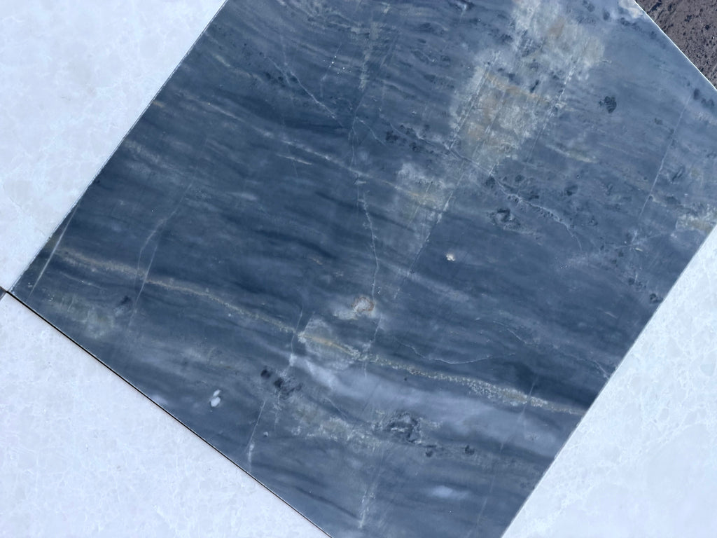 Dark blue-grey marble tile with white and light grey veining from Sky Blue Azul Cielo collection