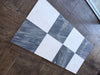 Gray and white checkered marble tile sample from Sky Blue Azul Cielo 18X18 collection