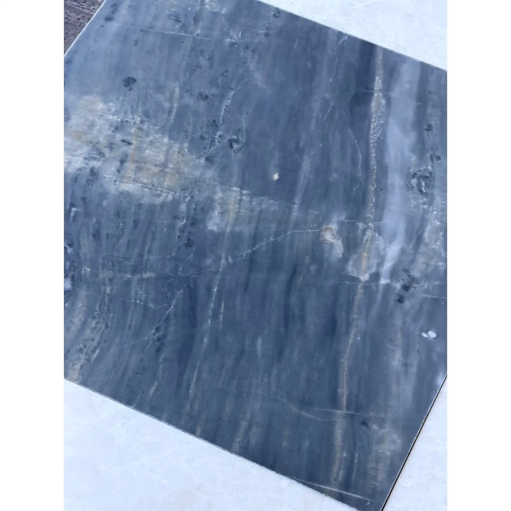 Polished dark gray marble slab with white veining and darker inclusions for Sky Blue Azul Cielo tile
