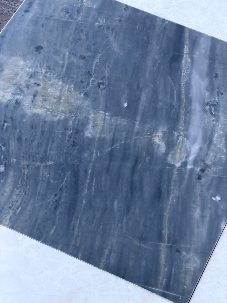 Polished dark gray marble slab with white veining and darker inclusions for Sky Blue Azul Cielo tile