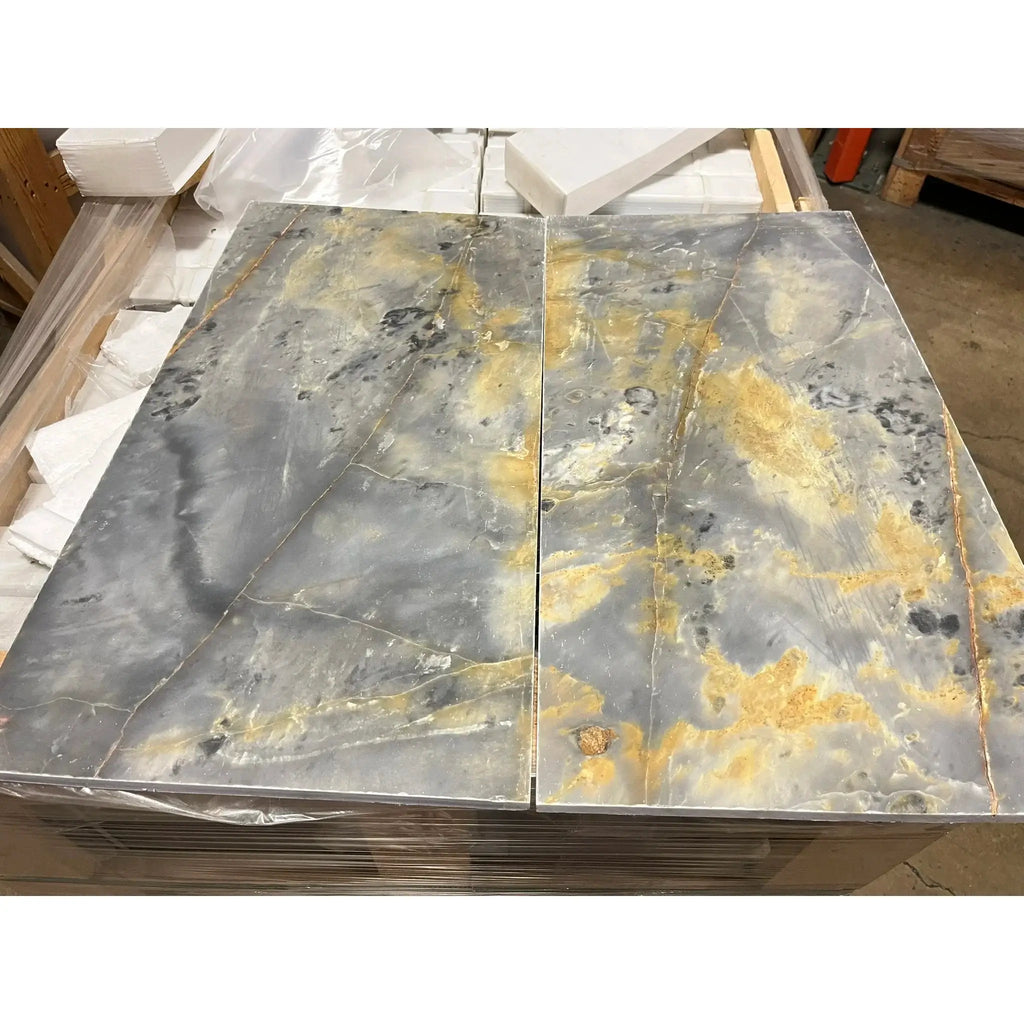 Gray and gold marble slabs in Sky Blue Azul Cielo 18X36 Marble Tile display