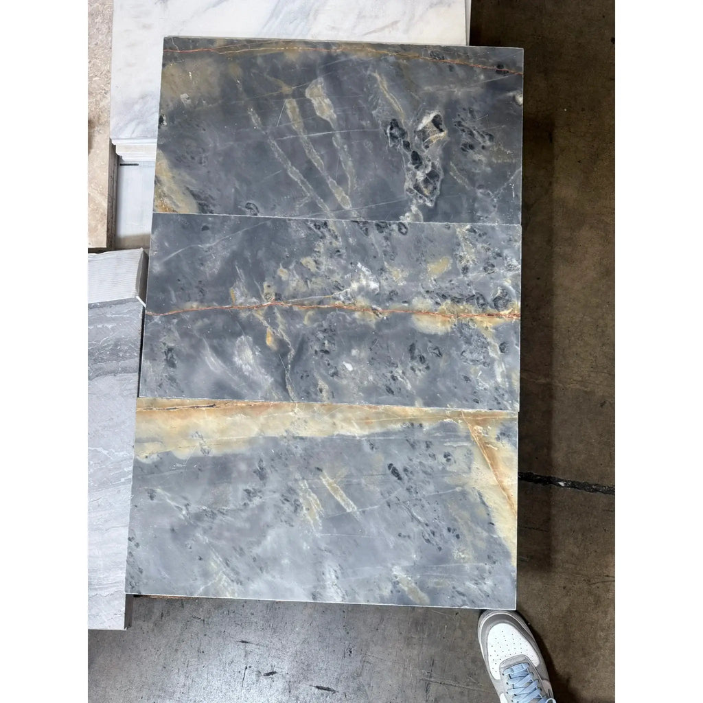 Gray marble slab with gold veining from Sky Blue Azul Cielo 18X36 Marble Tile