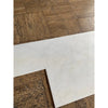 Snow White Marble 12x24 polished tiles on brown cork floor