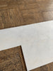 Snow White Marble 12x24 polished tiles on brown cork floor