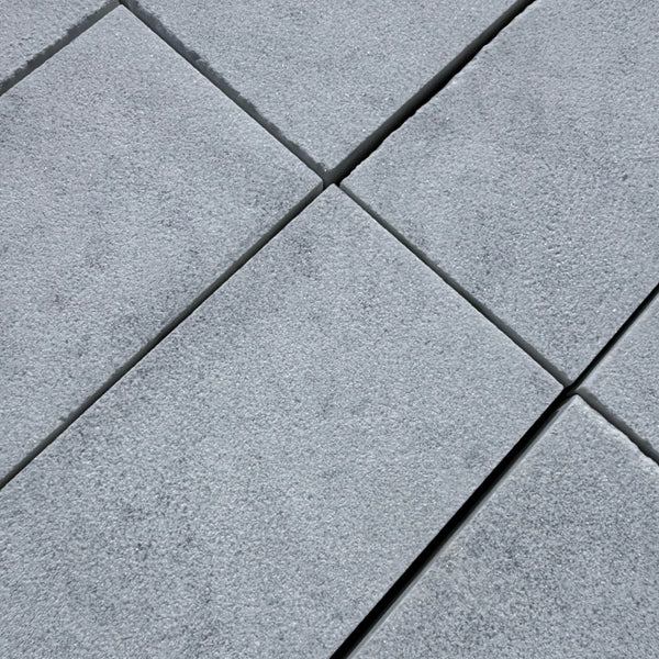 Gray textured paving stones featured in Snow White Marble Sand Blasted product
