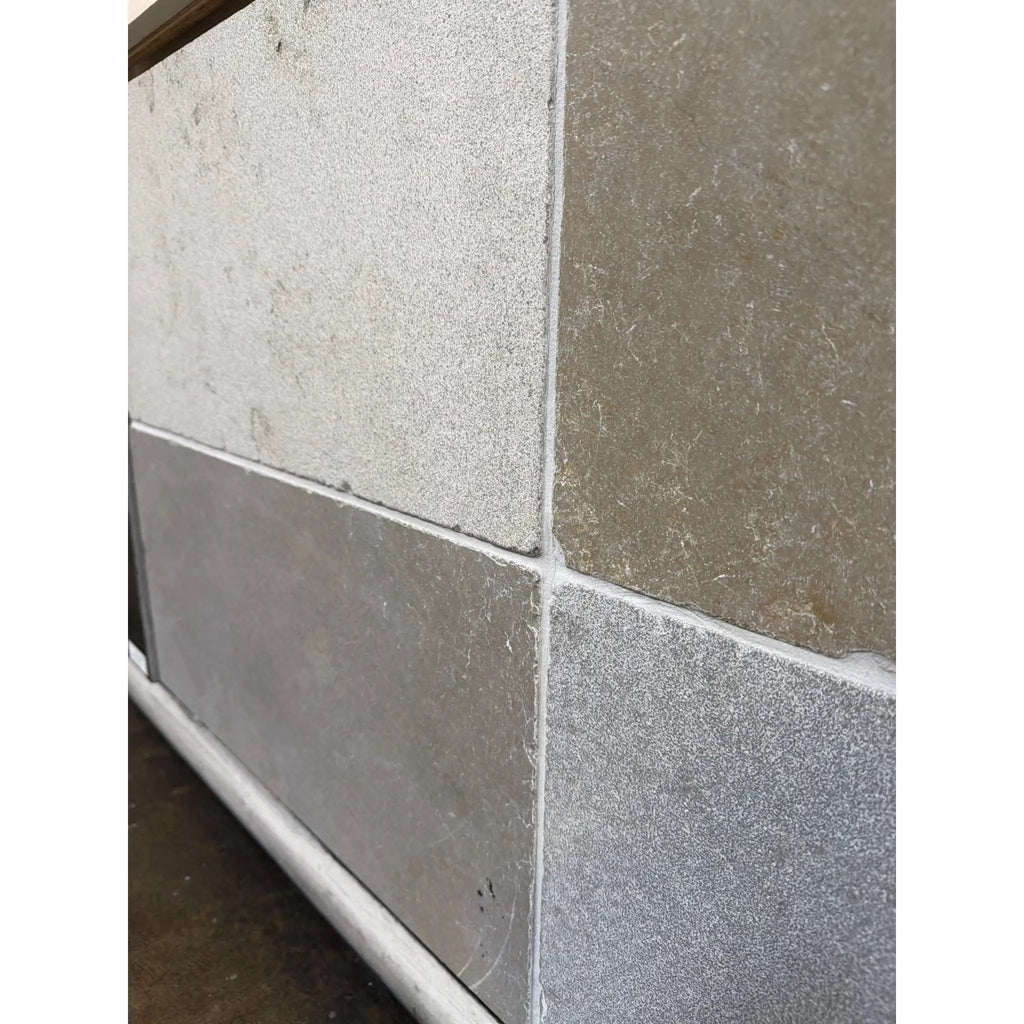 Gray Solaris 16x24 reclaimed limestone tiles with textured speckles and grout lines