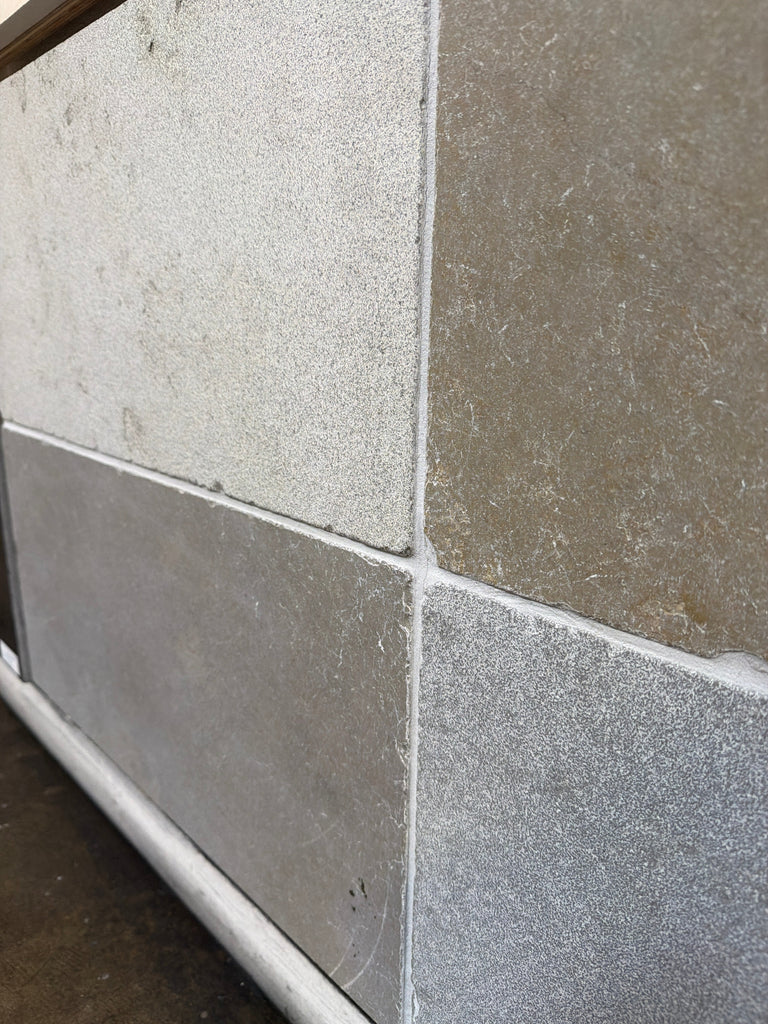 Gray Solaris 16x24 reclaimed limestone tiles with textured speckles and grout lines