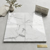 White Italian Statuario 12x12 premium marble tiles with elegant gray veining arranged in a four-square layout