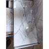 White marble-effect countertop panel with gray veining partially wrapped in clear plastic from statuario white 12x24 premium italian marble