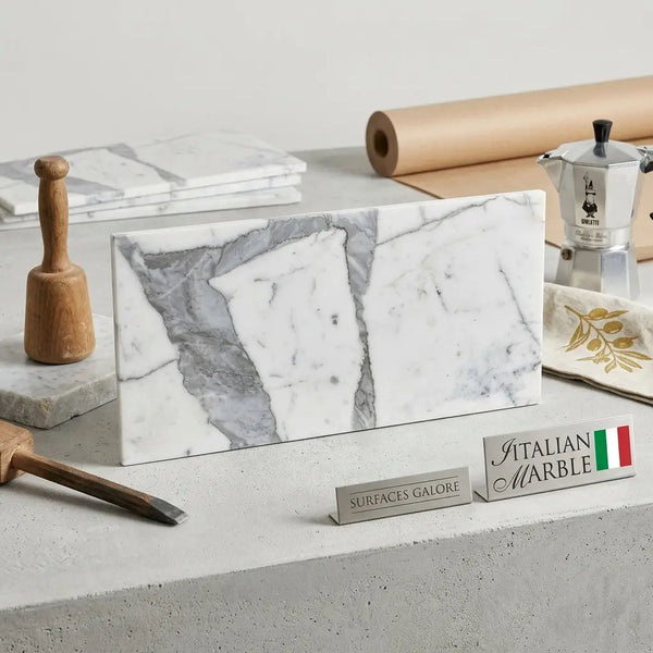 A sleek rectangular slab of statuario white 12x24 premium italian marble with natural gray veining and polished or honed finish