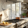 A gleaming copper pot on a stainless steel gas stove with statuario white 12x24 premium italian marble polished surface