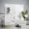 Statuario white 24x24 premium Italian marble polished tiles with gray veining displayed on a metallic base