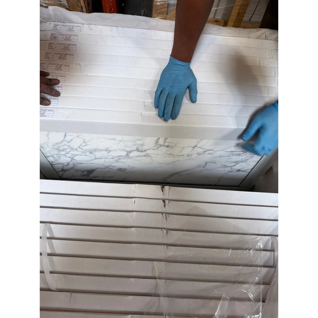 Stacked marble-patterned tiles from Statuary-Statuario White 18x18 Italian Marble collection