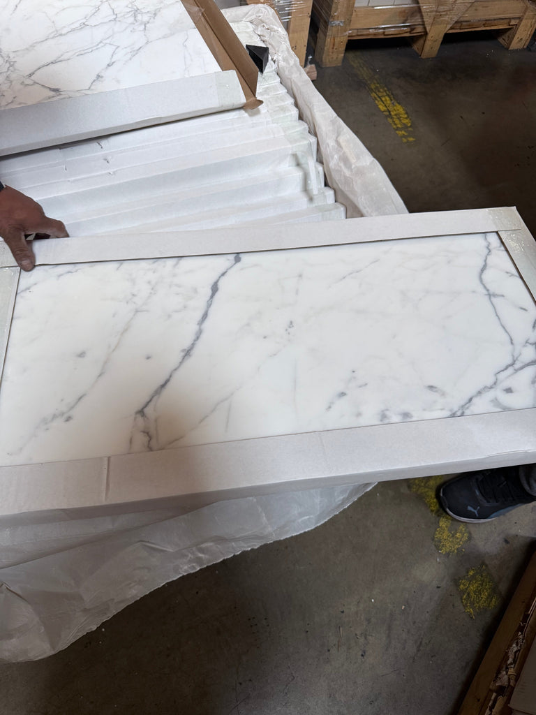 White marble-patterned tile with a white border from Statuary Statuario White 24X24 Italian Marble