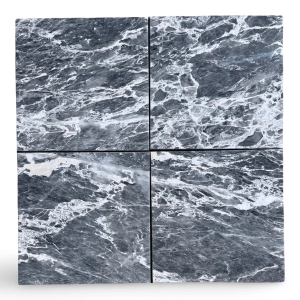 Four polished Storm Gray Marble 12x12 tiles with white veining for elegant flooring
