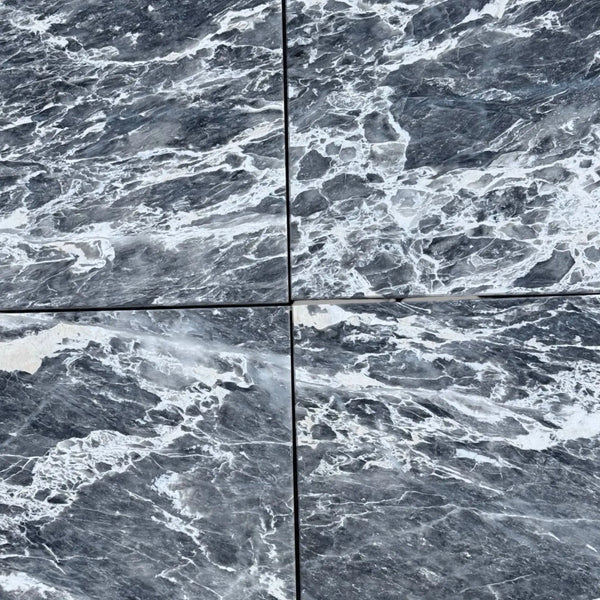 Four dark gray Storm Gray Marble 12x12 polished tiles with white veining