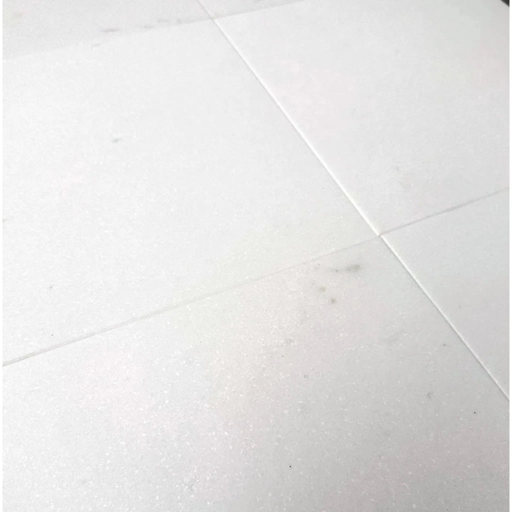 White tiled surface of Thassos White Marble 12X12 Honed Tile for elegant interiors