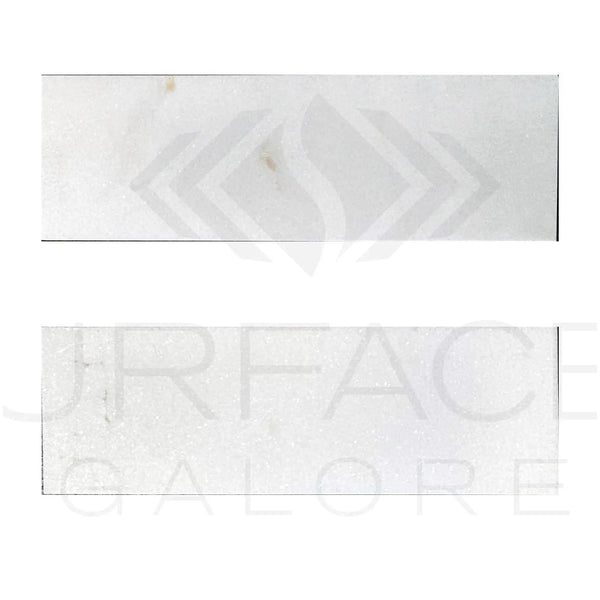 Two rectangular Thassos White Marble tiles displayed for sale, polished and standard quality