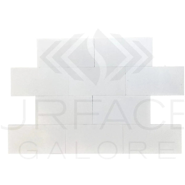 White brick wall pattern featuring Thassos White Marble polished tile 6X12 for $8.99/Sq.Ft
