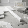 A sleek white marble quarter-round trim with polished finish and subtle veining for upscale interior detailing