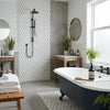 Black clawfoot bathtub with white interior and wooden brush on edge featuring Thassos white 1x2 diamond rhomboid marble mosaic