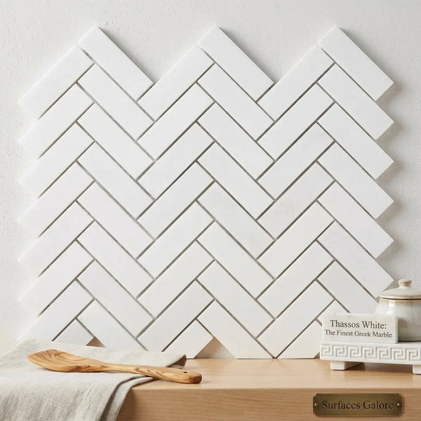 Thassos white 1x3 herringbone mosaic polished marble tile wall with a white herringbone patterned marble surface