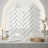 White greek marble tiles in a polished herringbone mosaic pattern showcasing thassos white 1x4 marble design