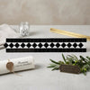 Black and white marble tile border with geometric diamond pattern thassos white 2x12 bias border with black polished or honed