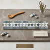 Thassos white 2x12 bias border marble tile strip with repeating gray and white diamond pattern in polished greek marble