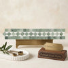 A sleek rectangular mosaic tile bench with light green and white Thassos marble in a geometric diamond pattern