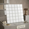 A sheet of polished greek thassos white marble tiles arranged in a grid pattern for mosaic use