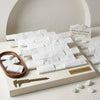 Thassos white 2x4 brick mosaic marble split-faced tiles in white Greek marble with subtle gray veining on display board