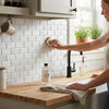 White subway tile backsplash made of thassos white 2x4 deep-beveled brick mosaic marble polished-honed