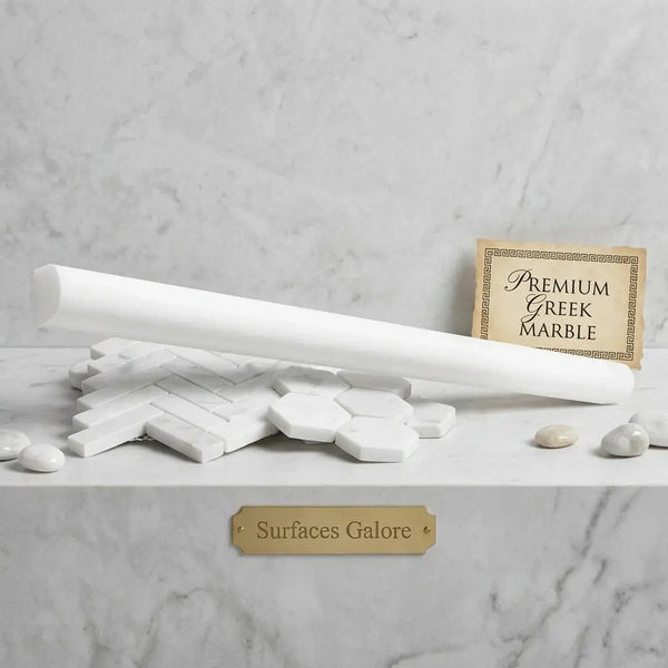 A sleek cylindrical white marble thassos white 3/4x12 bullnose liner polished rod on hexagonal and rectangular tiles