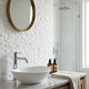 White ceramic vessel sink with sleek modern design complementing Thassos white 3/8x1 mini-brick mosaic marble split-faced tile