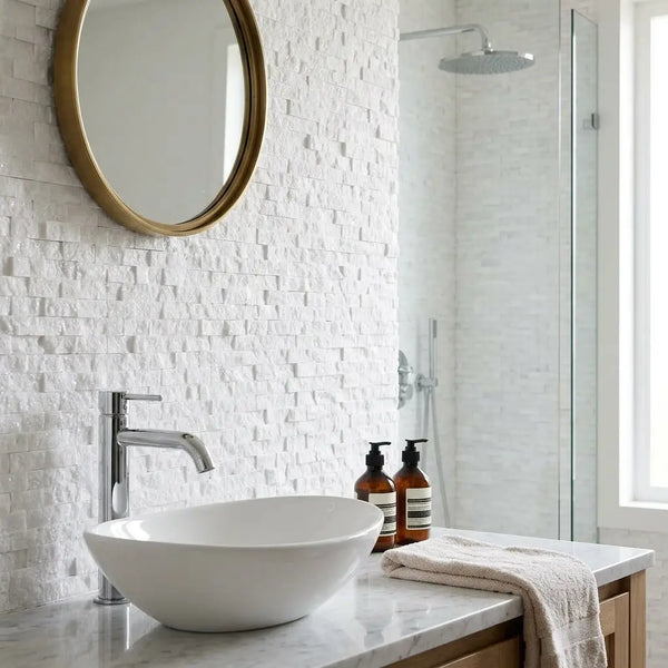 White ceramic vessel sink with sleek modern design complementing Thassos white 3/8x1 mini-brick mosaic marble split-faced tile