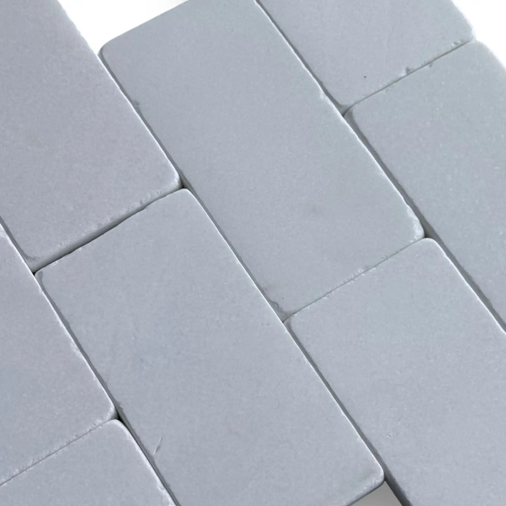 Gray brick pattern on Thassos White 3X6 Marble Tumbled tile product