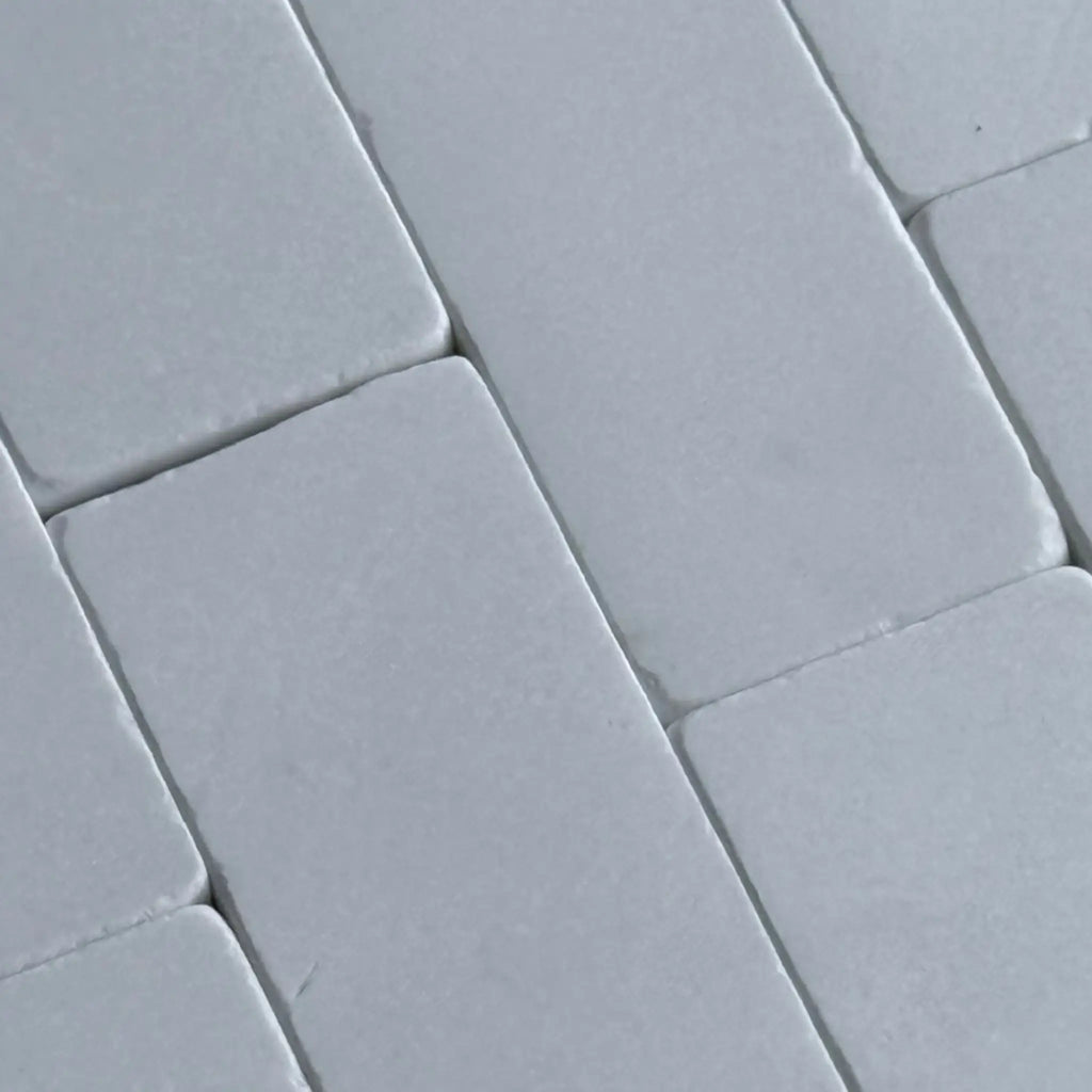 Gray rectangular tiles from the Thassos White 3X6 Marble Tumbled collection