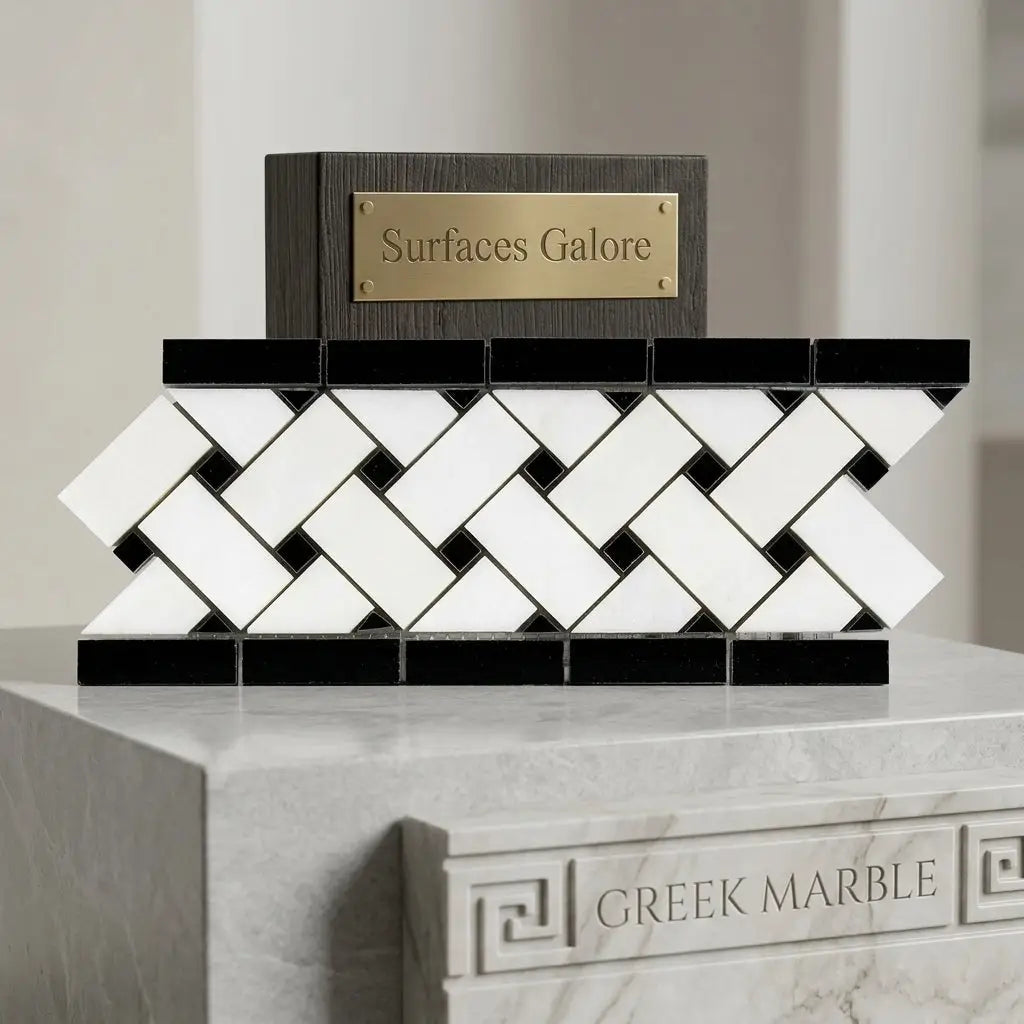 Black and white herringbone mosaic tile with dark wood base and gold plaque thassos white marble polished basketweave border